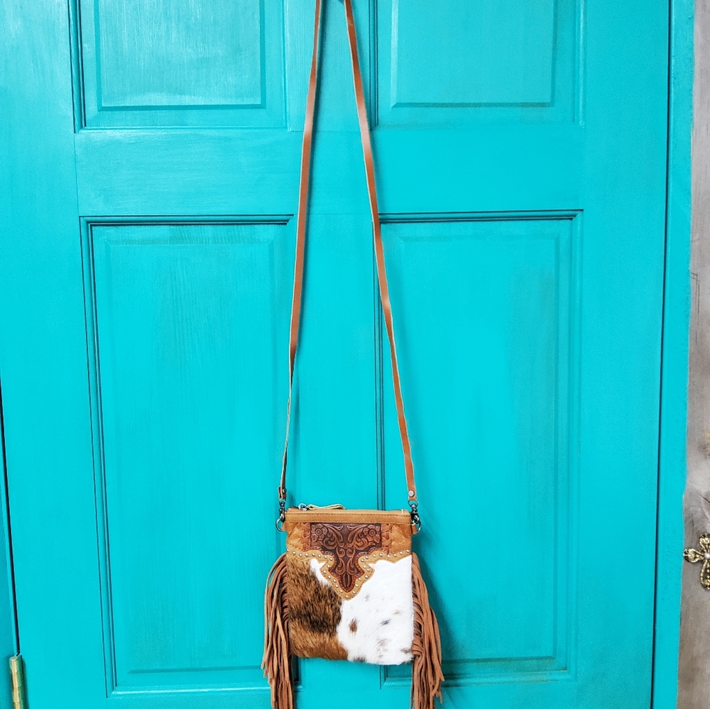 Small, brown and white crossbody purse.